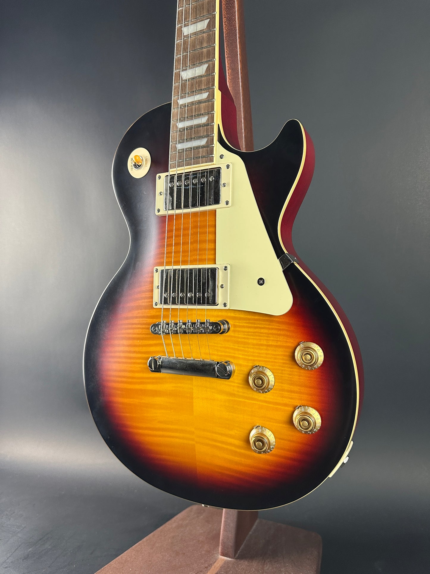 Electric guitar with a sunburst finish on a dark background