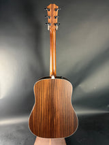 Wooden acoustic guitar on a gray background