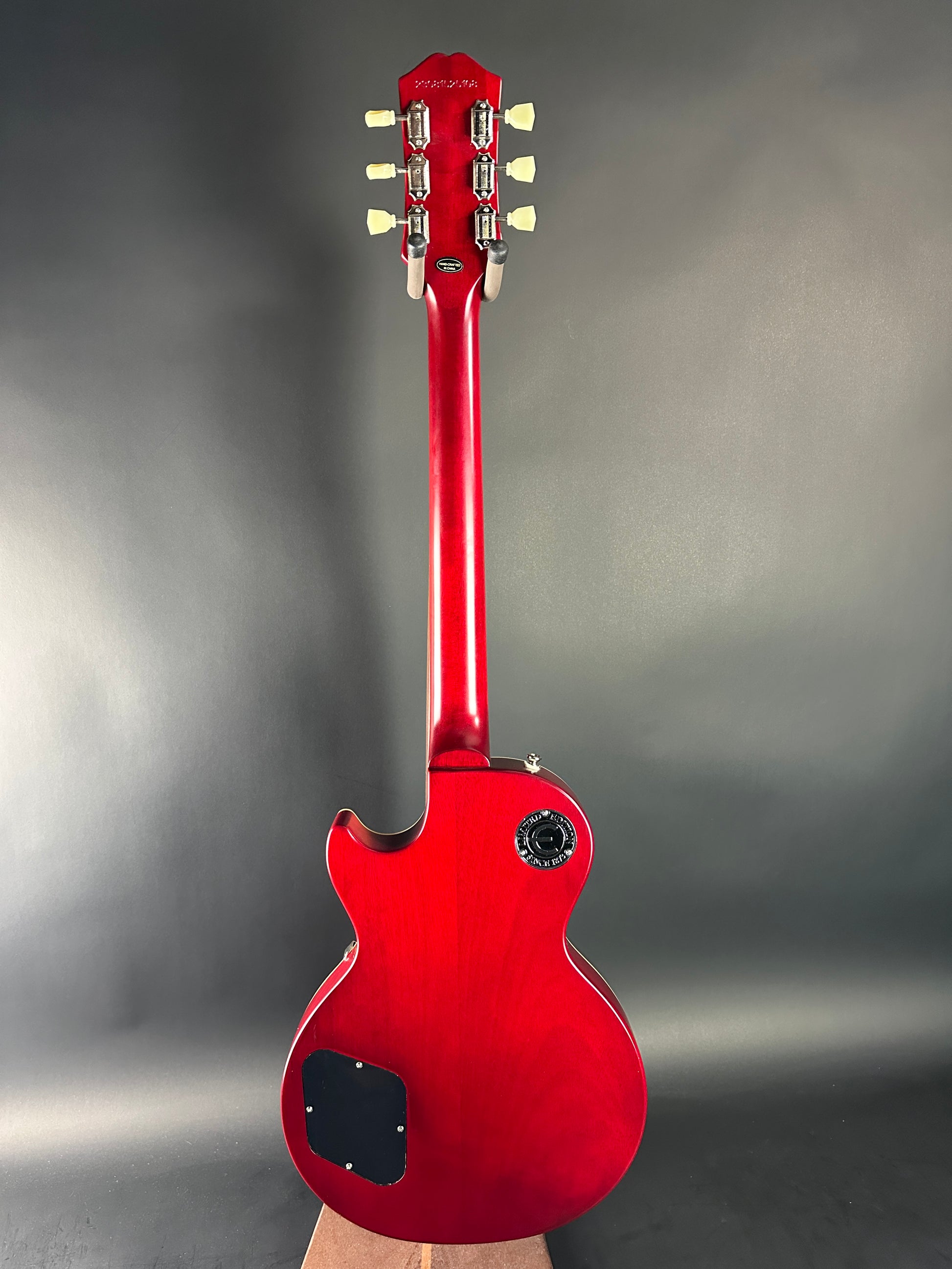 Red electric guitar on a gray background