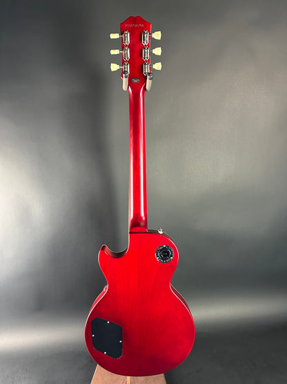 Red electric guitar on a gray background
