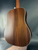 Close-up of a wooden acoustic guitar on a dark background