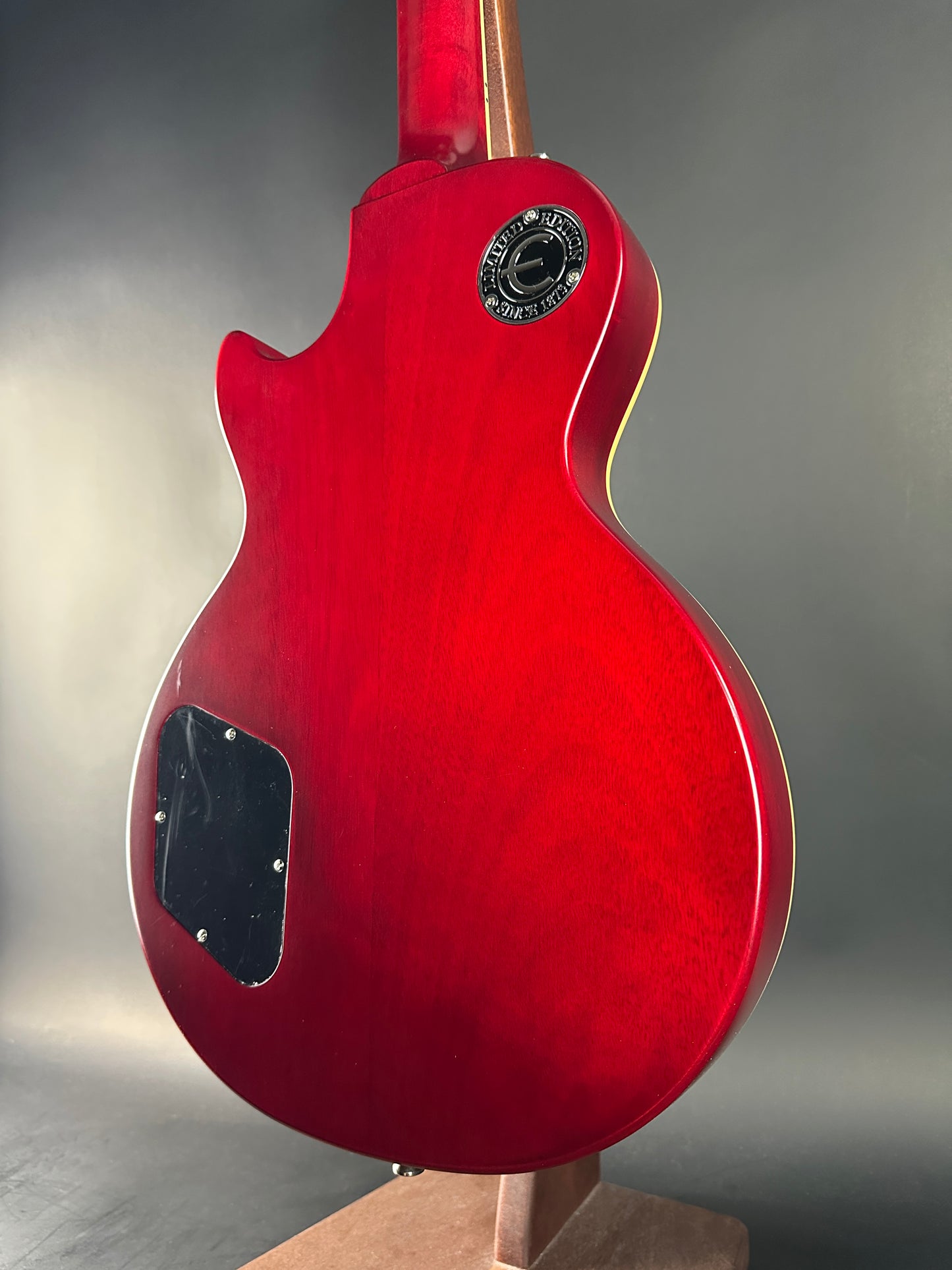 Red electric guitar on a gray background