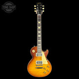 A classic electric guitar with a sunburst finish, shown from the front against a solid black background. The brand 'Tone Shop' is visible as a watermark in the top-left corner.