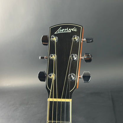 Guitar headstock with 'Larrivee' branding on a gray background