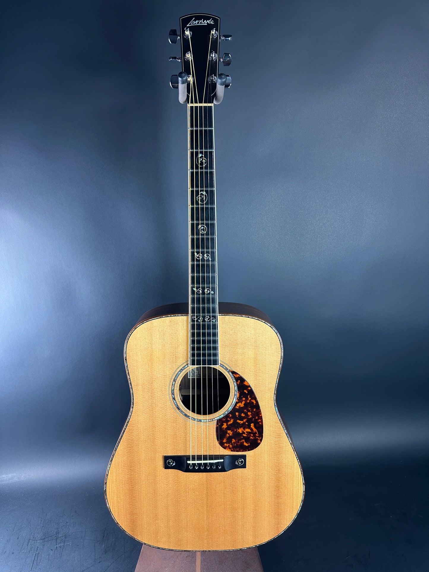 Acoustic guitar on a dark blue gradient background