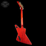 A red electric guitar shown from the back against a solid black background, with a Tone Shop watermark in the upper left corner.
