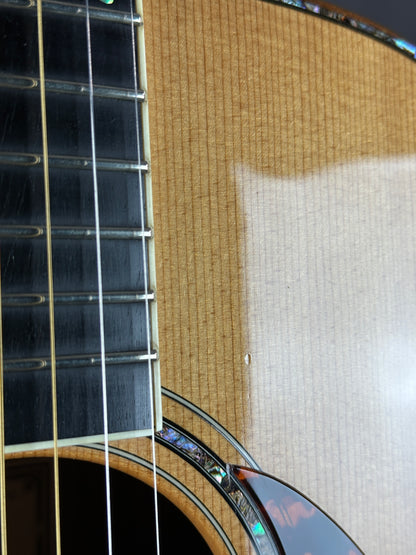 Close-up of an acoustic guitar's soundhole and neck