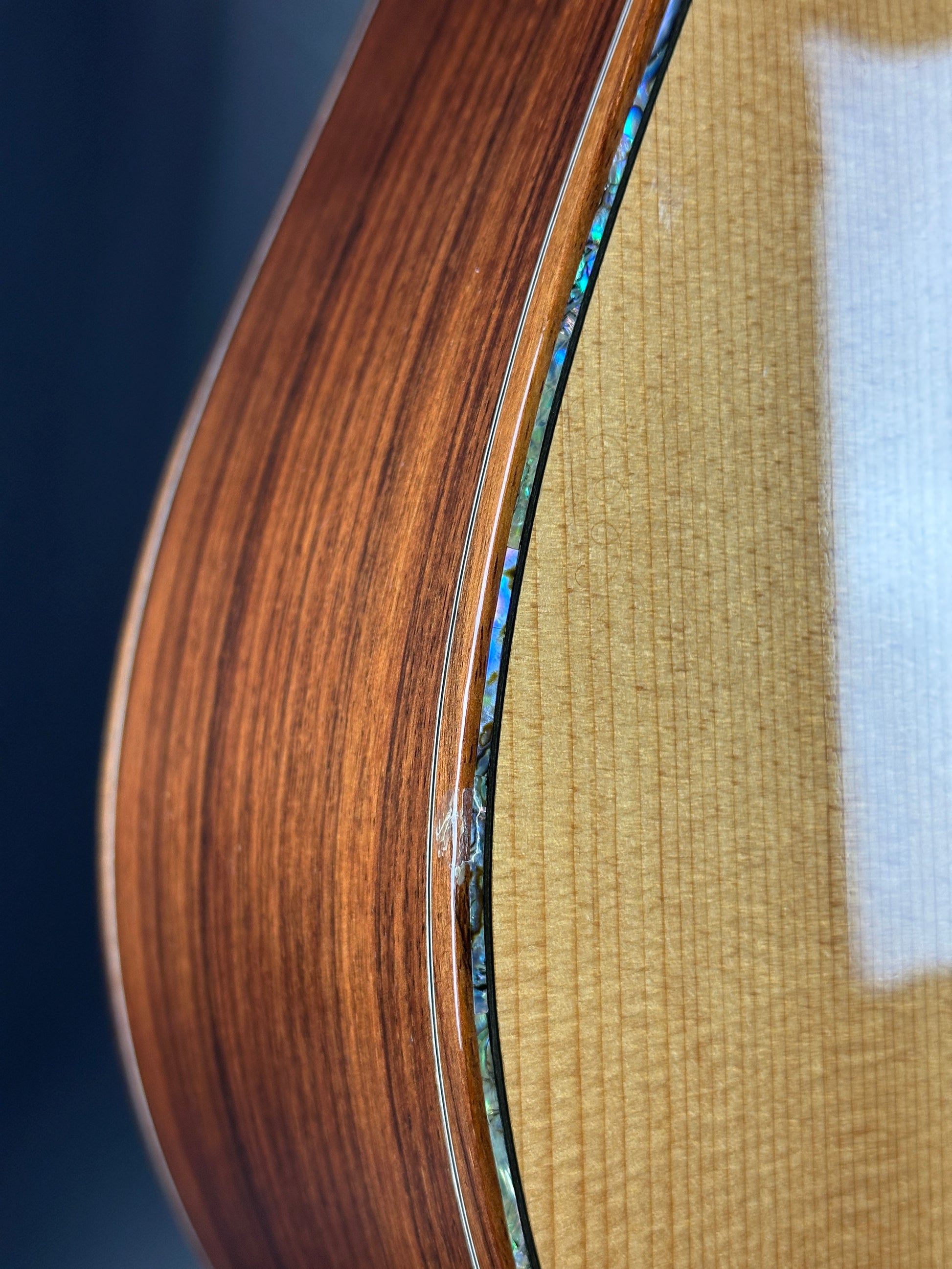 Close-up of a wooden guitar neck with a clear finish