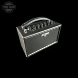 A small BOSS guitar amplifier with a dark gray textured metal cabinet, silver control knobs, and a top handle, shown against a solid black background.