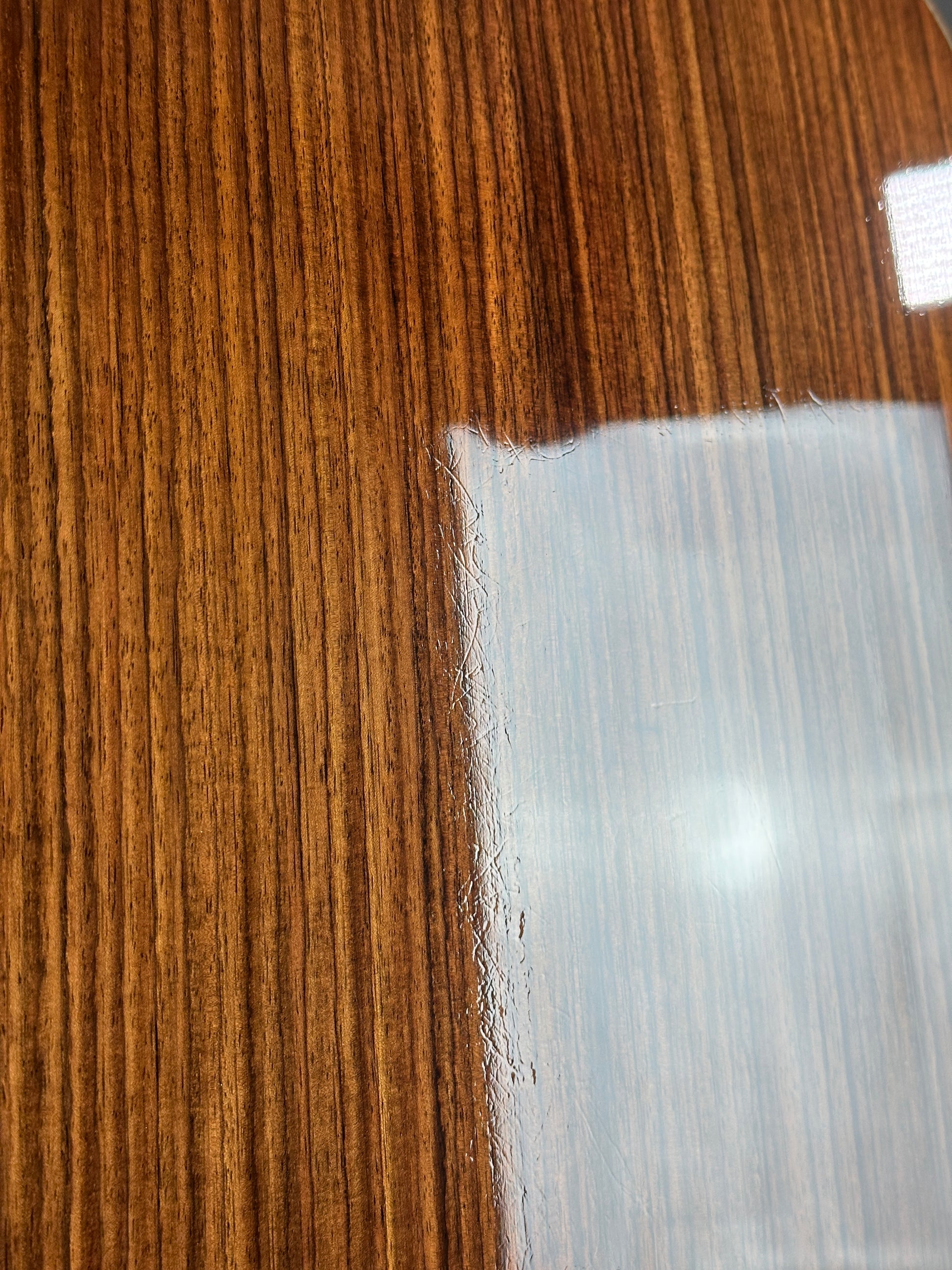 Close-up of a wooden surface with a piece of white tape on it