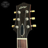 Close-up of the headstock of a vintage acoustic guitar, featuring a dark wood finish, six tuning pegs, and the 'Collings' brand name in white script. The headstock is shown against a solid black background with a 'TONE SHOP' watermark in the upper left corner.