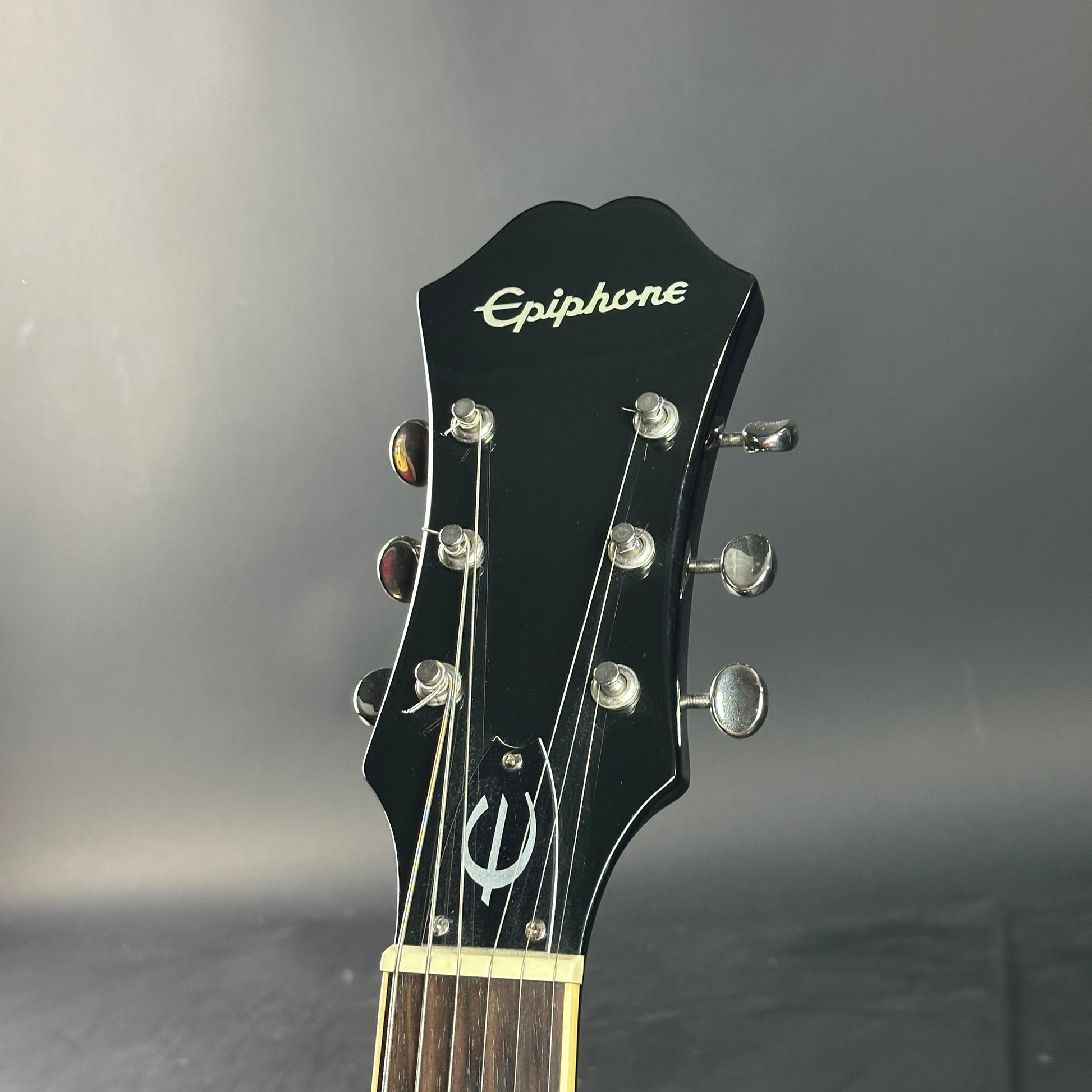Epiphone guitar headstock on a gray background
