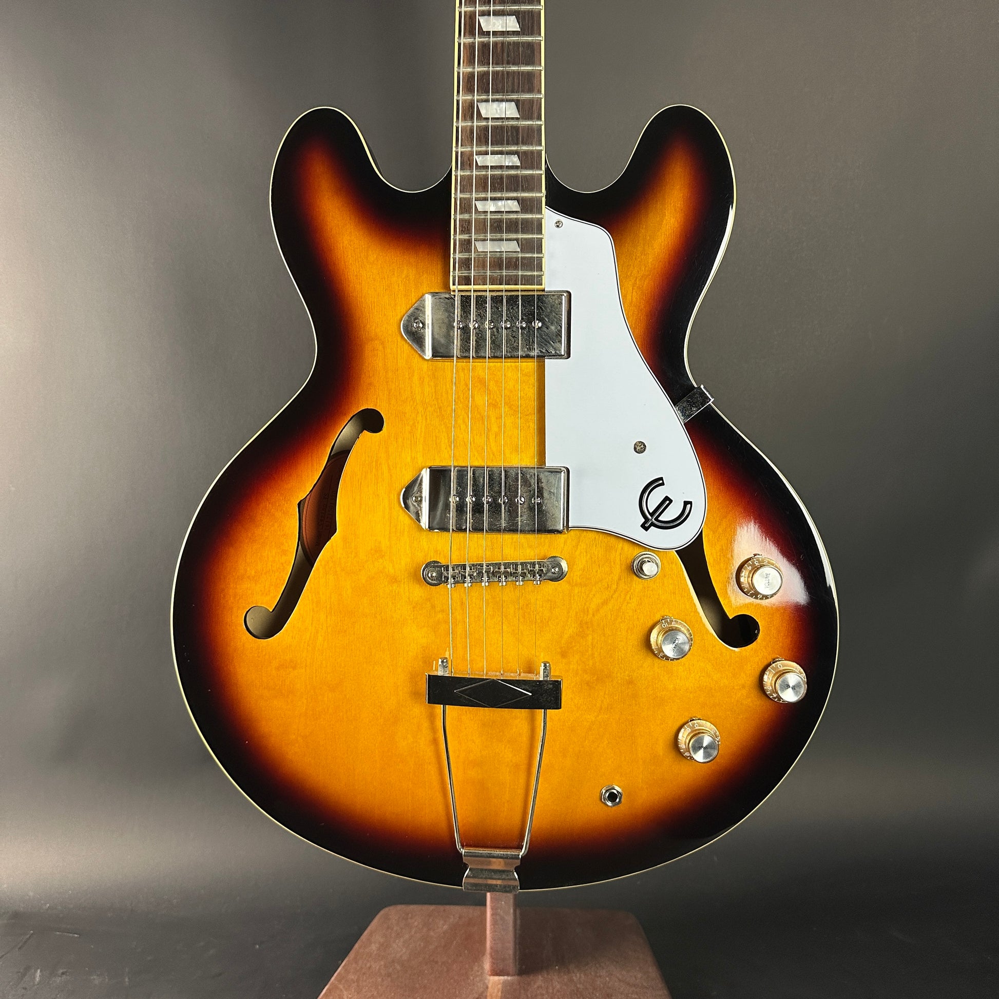 Electric guitar with a sunburst finish on a gray background