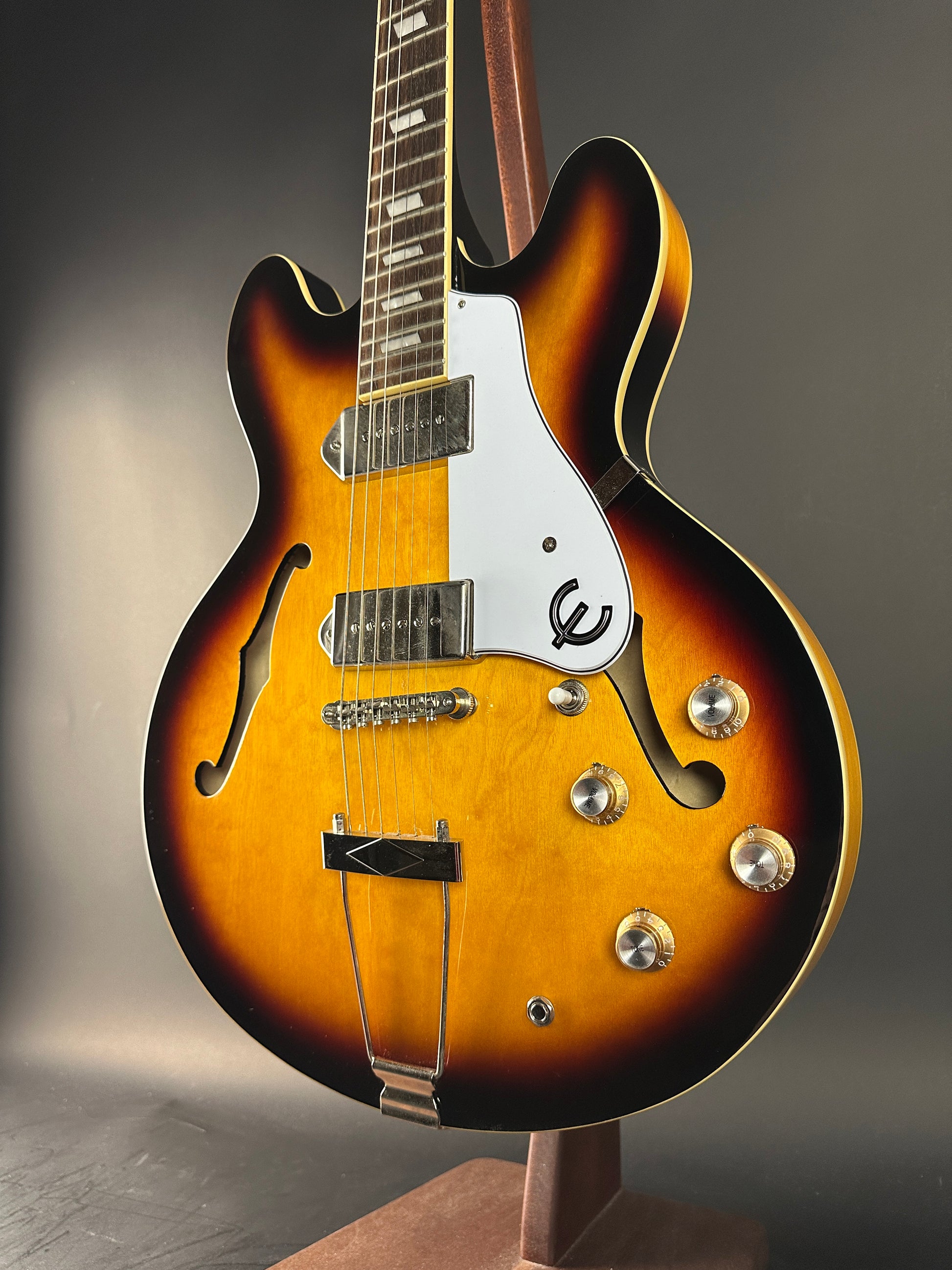 Close-up of a sunburst electric guitar on a gray background