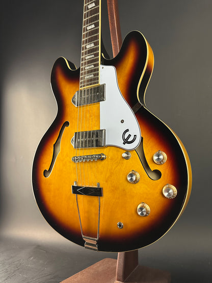 Close-up of a sunburst electric guitar on a gray background