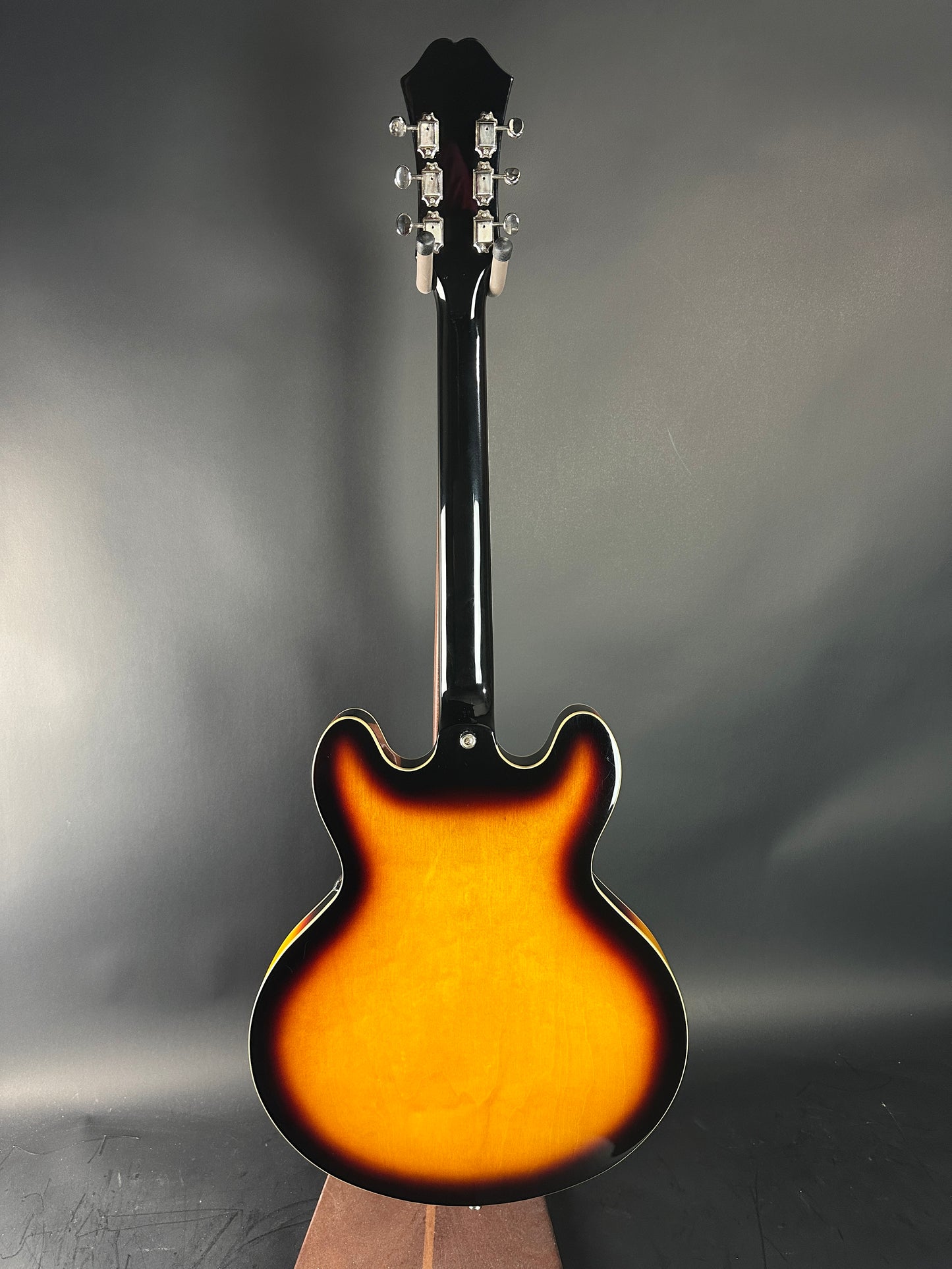 Electric guitar with a sunburst finish on a gray background
