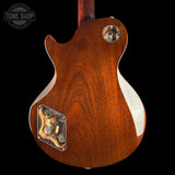 The back of an electric guitar with a glossy reddish-brown wood finish, featuring a chrome-covered volume pot and a chrome-covered pickup cover, shown against a solid black background.