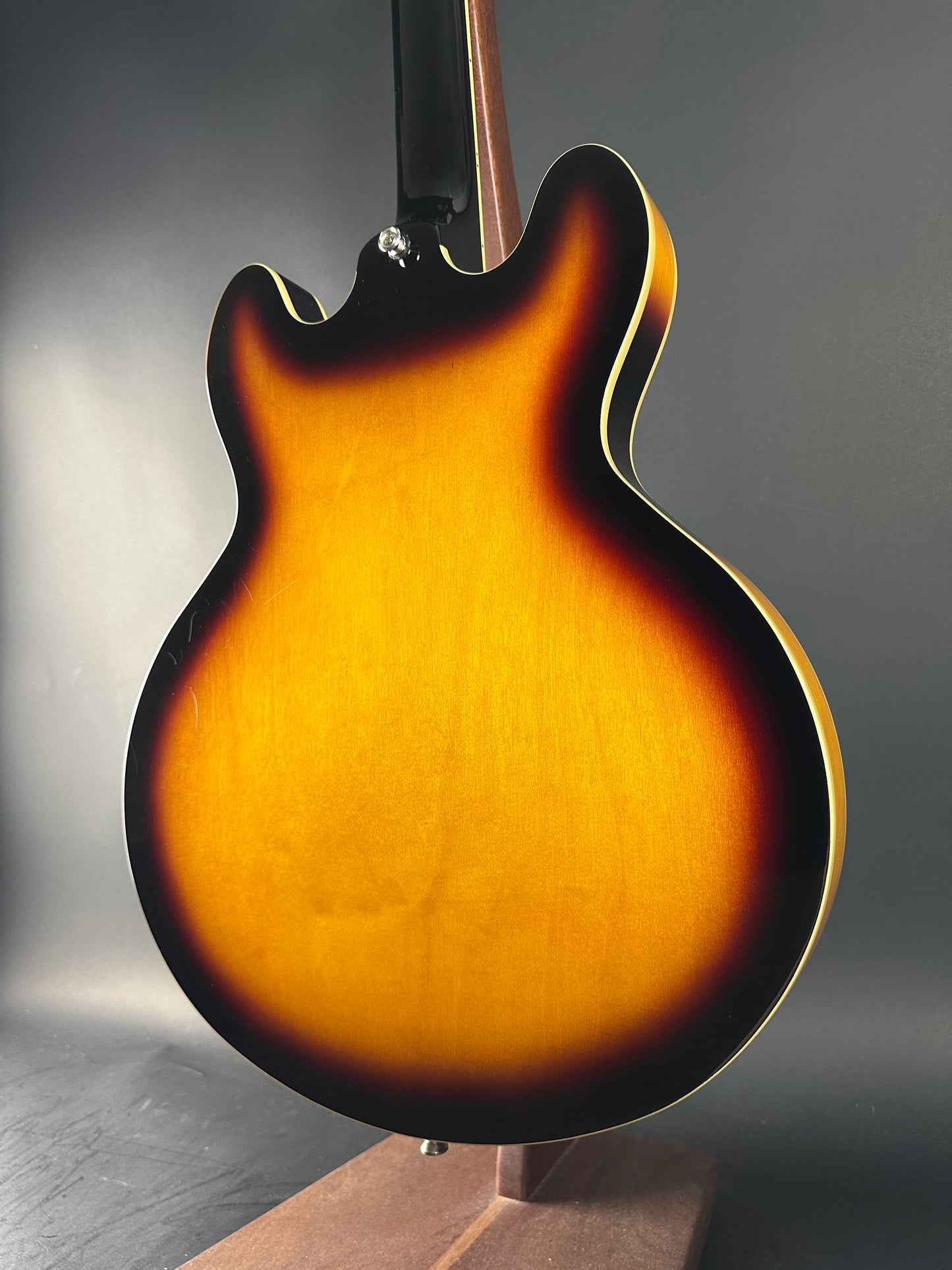 Close-up of a sunburst electric guitar on a dark background