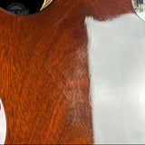 Close-up of a reddish-brown wooden surface with visible scratches and a large white rectangular area obscuring part of the right side.
