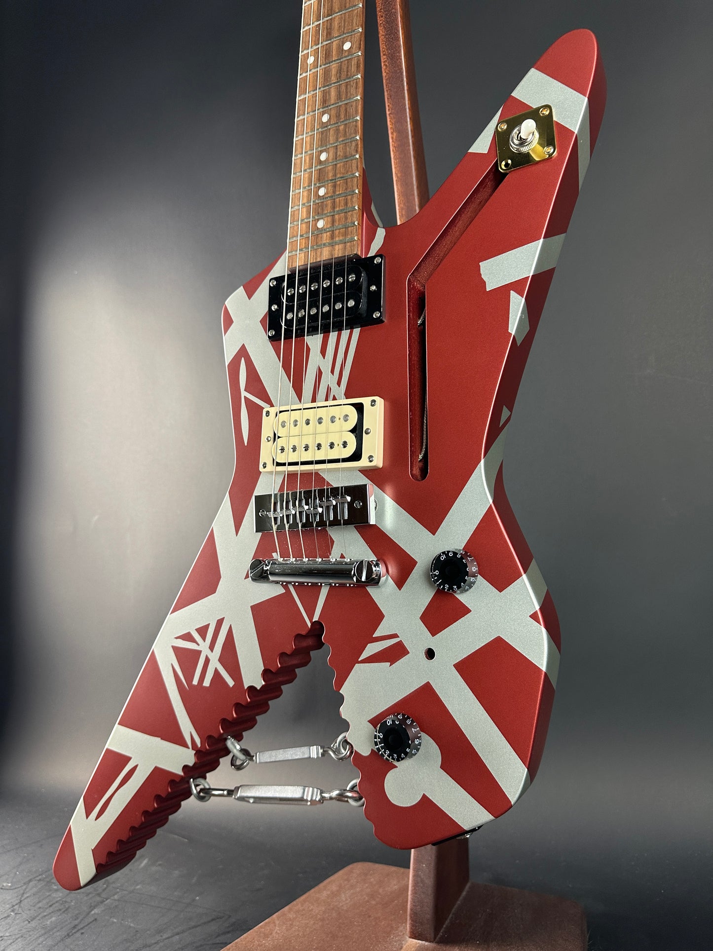Red and white electric guitar with unique design on a dark surface