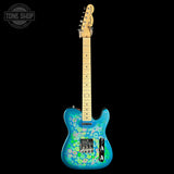 A Fender Telecaster-style electric guitar with a vibrant blue body featuring a colorful floral pattern, set against a solid black background. The headstock is light wood, and the neck is also light wood.