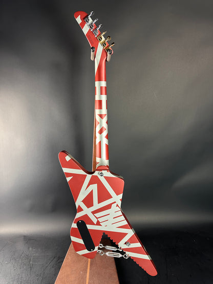 Red and white guitar with a unique design on a gray background