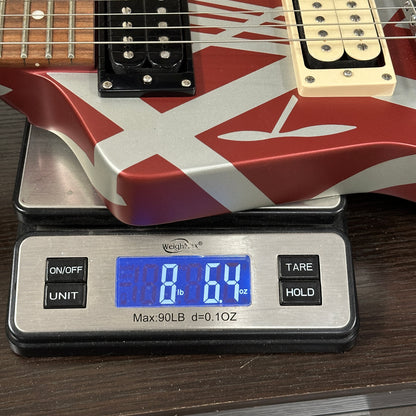 Guitar on a digital scale displaying weight