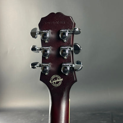 Guitar headstock with Epiphone logo on a gray background