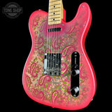 A pink electric guitar with a floral and paisley pattern on the body, featuring a natural maple neck, black hardware, and a black pickguard, shown against a black background with a Tone Shop watermark.