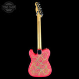 A pink electric guitar with a gold paisley pattern on the body, shown from the back against a solid black background. A Tone Shop watermark is visible in the top-left corner.