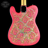 A Telecaster-style electric guitar body shown from the back, featuring a vibrant pink border and an intricate paisley pattern in pink, green, and gold over a light beige base. The neck joint is visible at the top against a solid black background, with a Tone Shop watermark in the upper left corner.