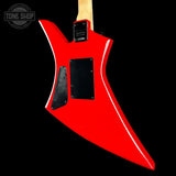 A bright red electric guitar body shown from the back against a solid black background, featuring a distinctive angular shape, black hardware covers, and a light wood neck visible at the top.