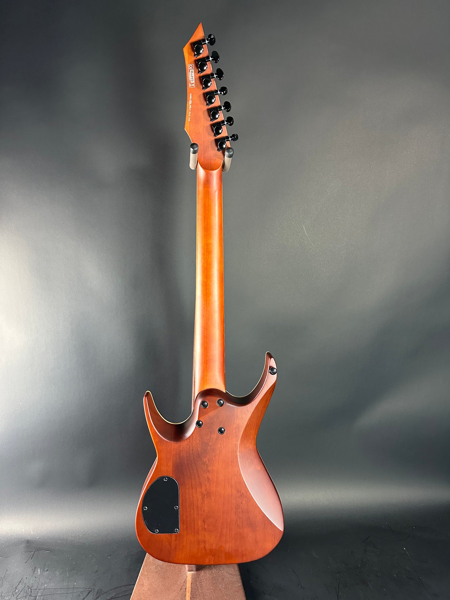 Wooden electric guitar on a gray background