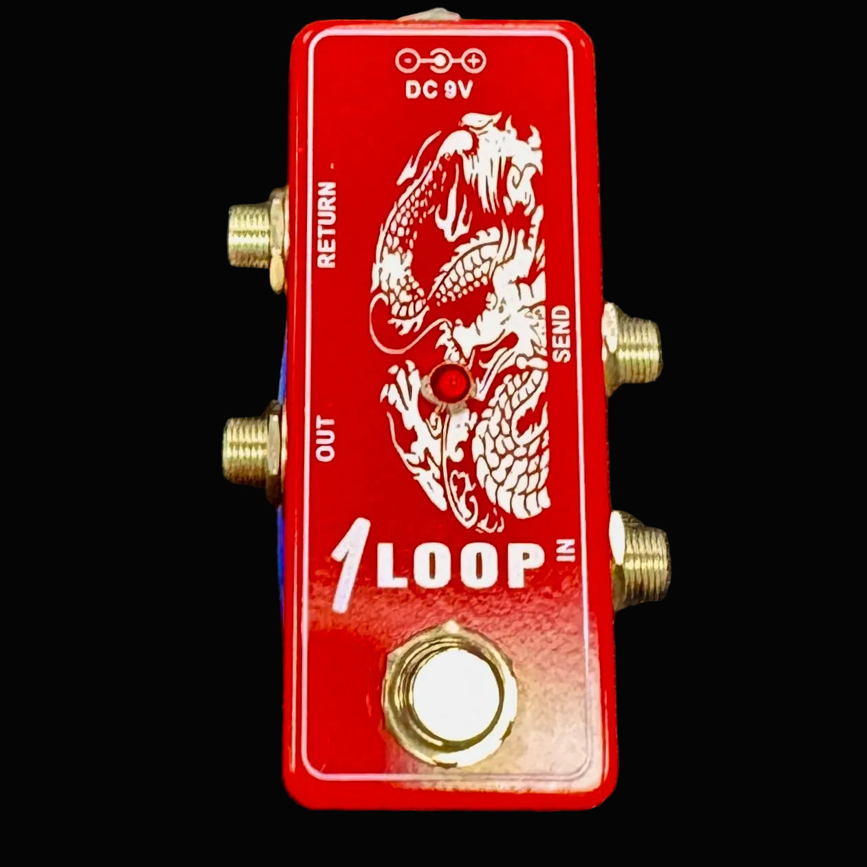 Red guitar effects pedal with dragon design on a dark textured background