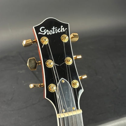 Gretsch guitar headstock on a dark background