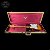 Electric guitar in a open case with a visible brand logo on a black background