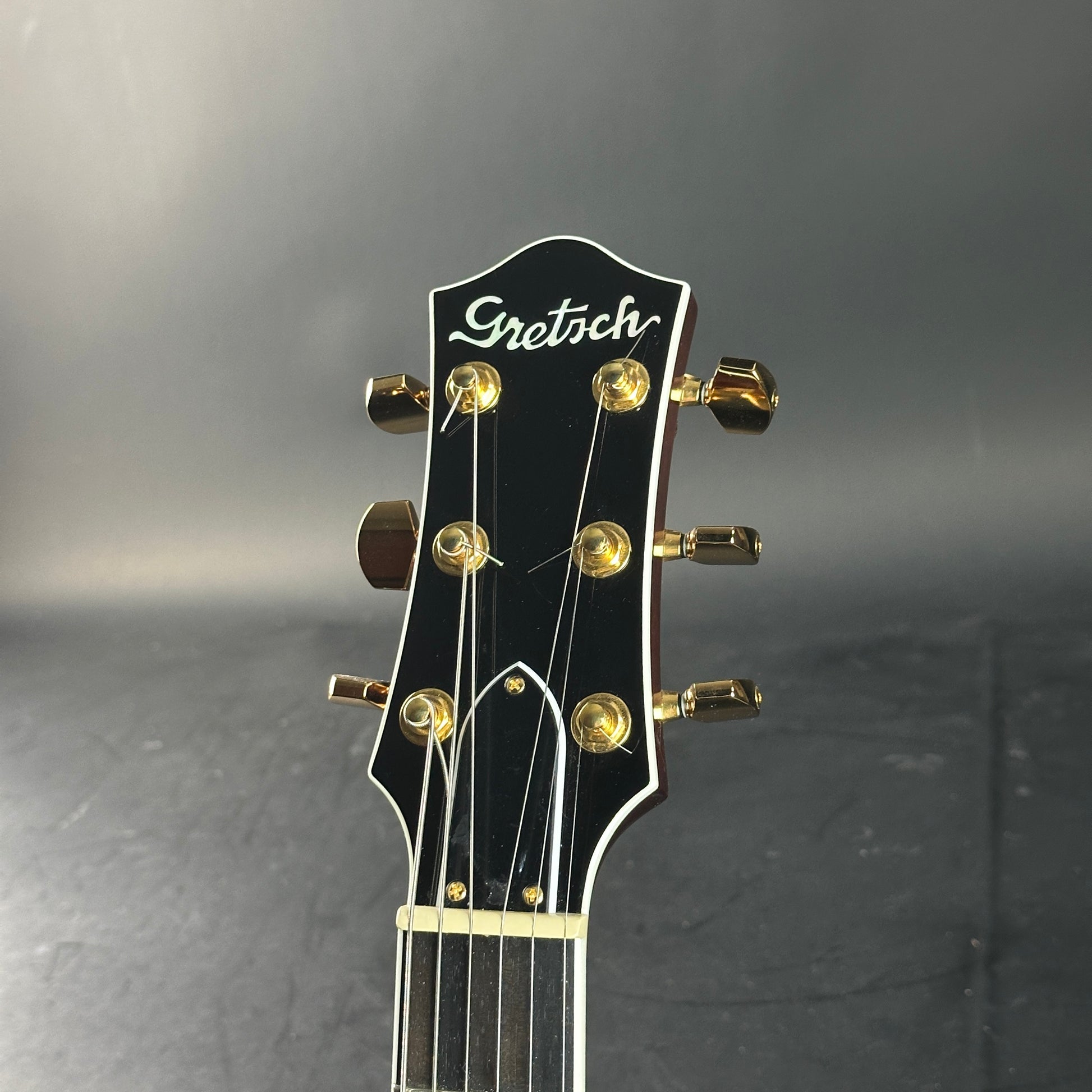 Gretsch guitar headstock on a dark background