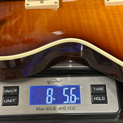 Guitar on a digital scale displaying weight