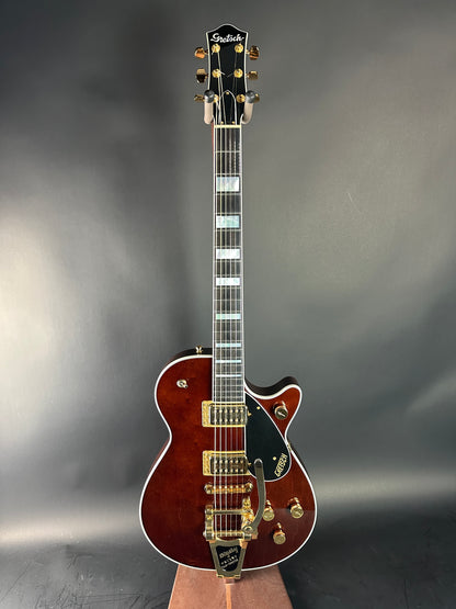 Electric guitar with a brown finish on a gray background