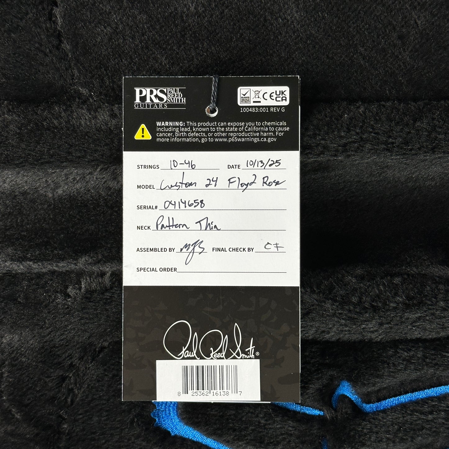 PRS guitar label with model details on a textured black background