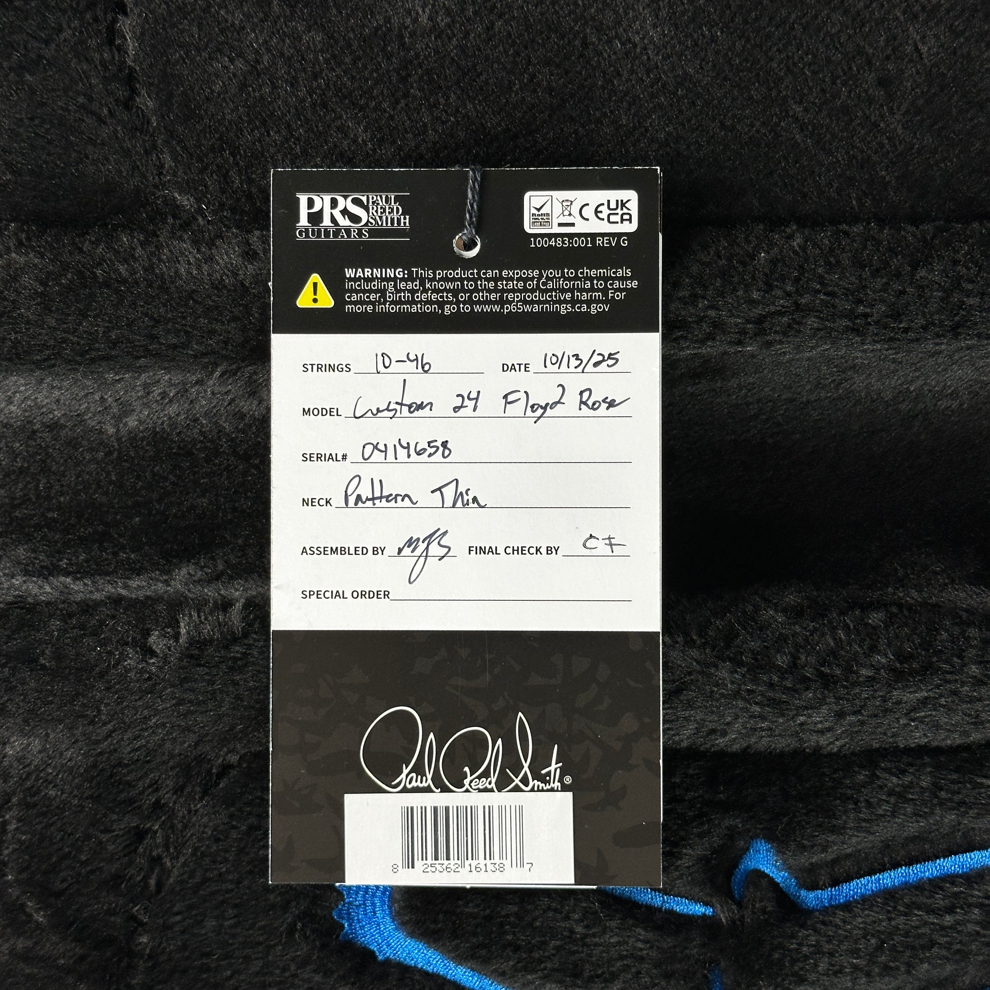PRS guitar label with model details on a textured black background