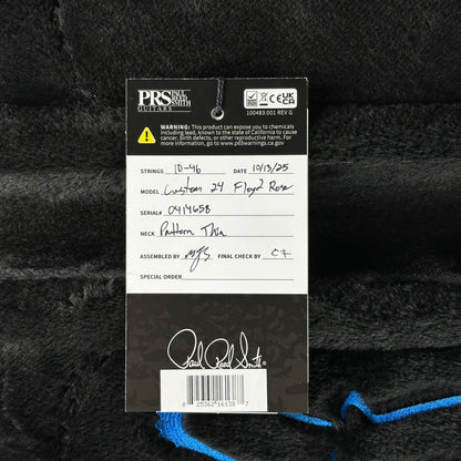 PRS guitar label with model details on a textured black background