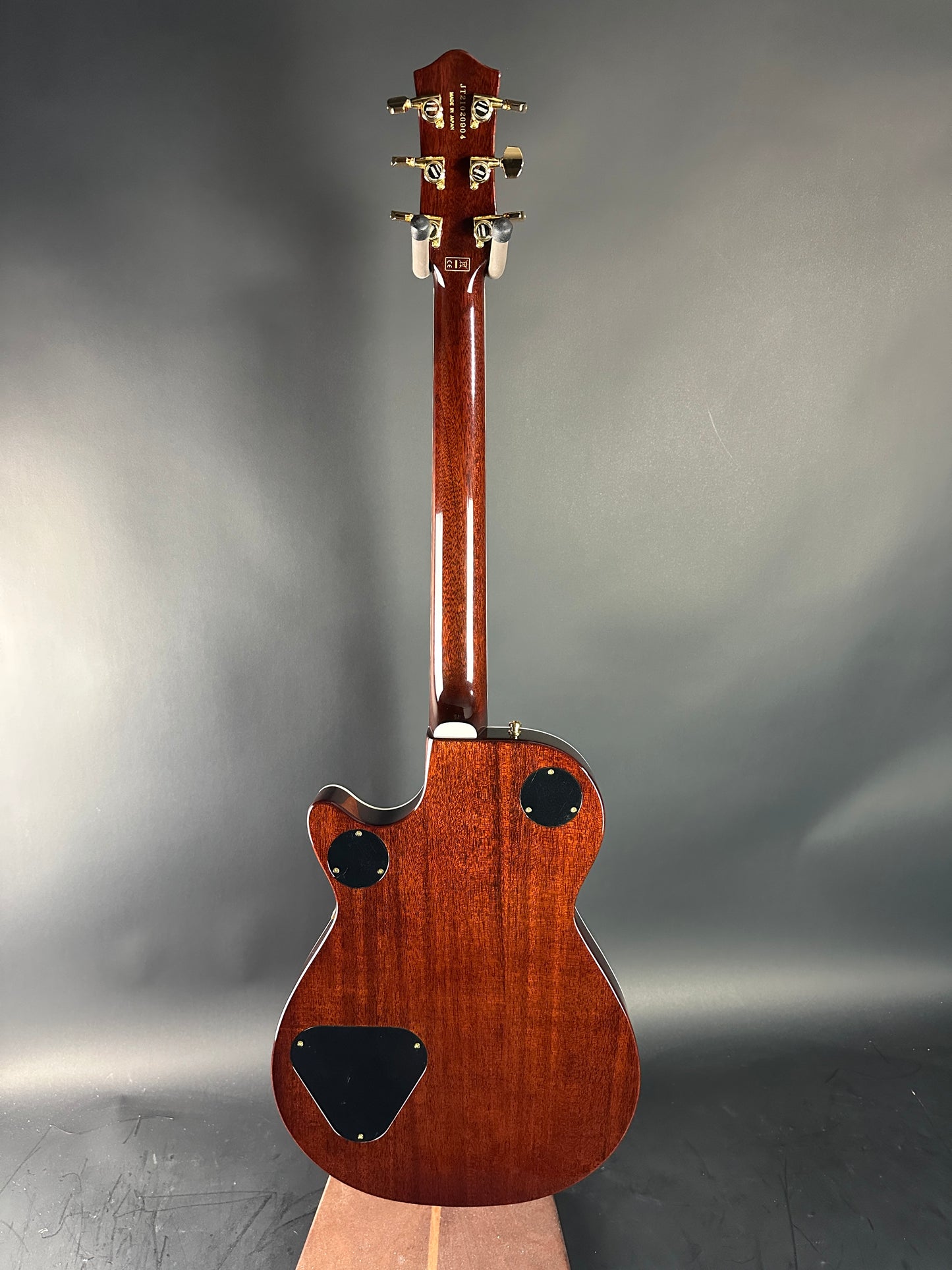 Wooden electric guitar on a gray background