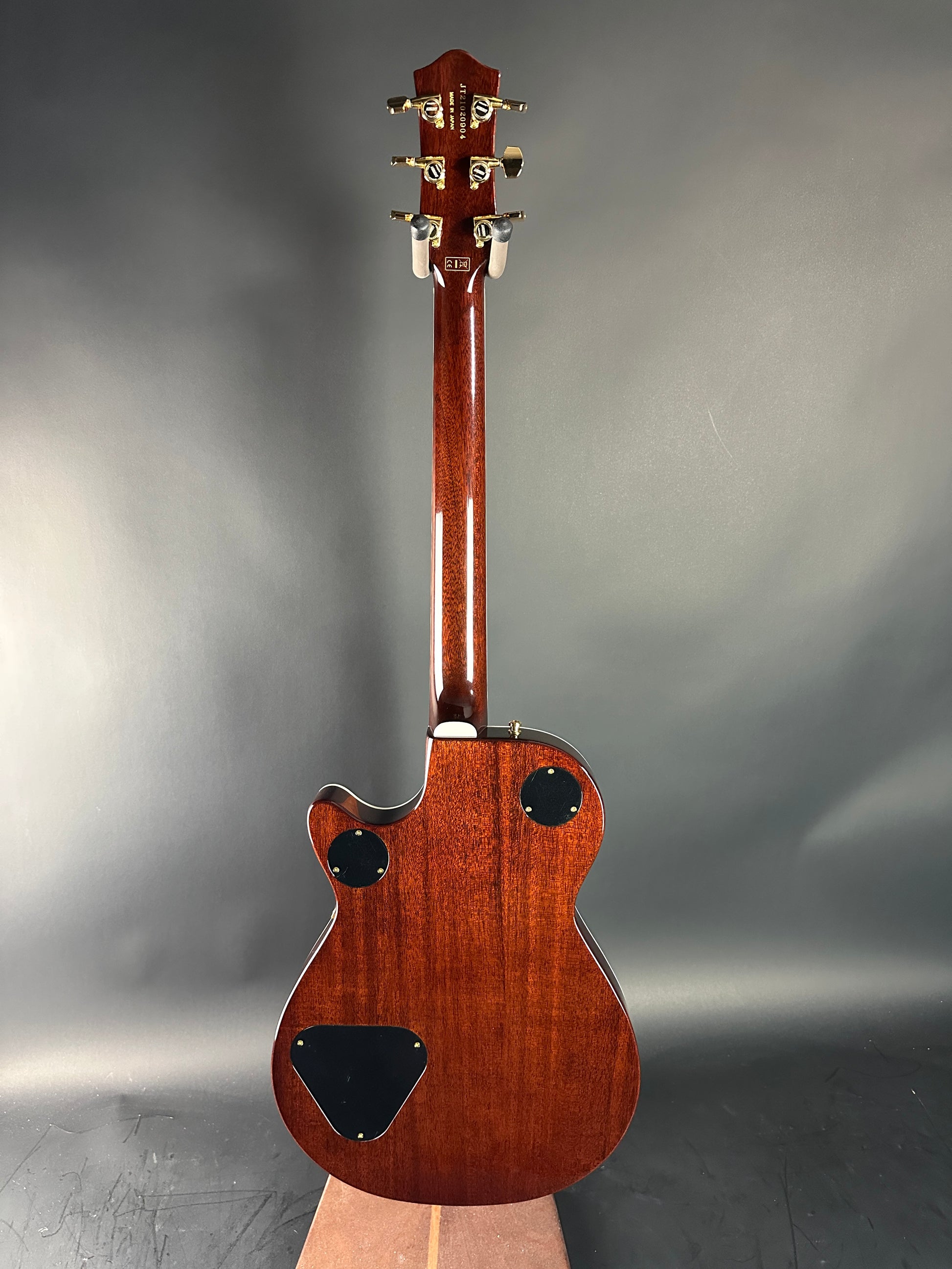 Wooden electric guitar on a gray background