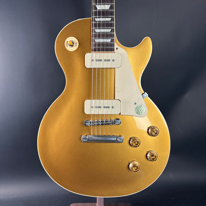 Gold electric guitar on a dark background