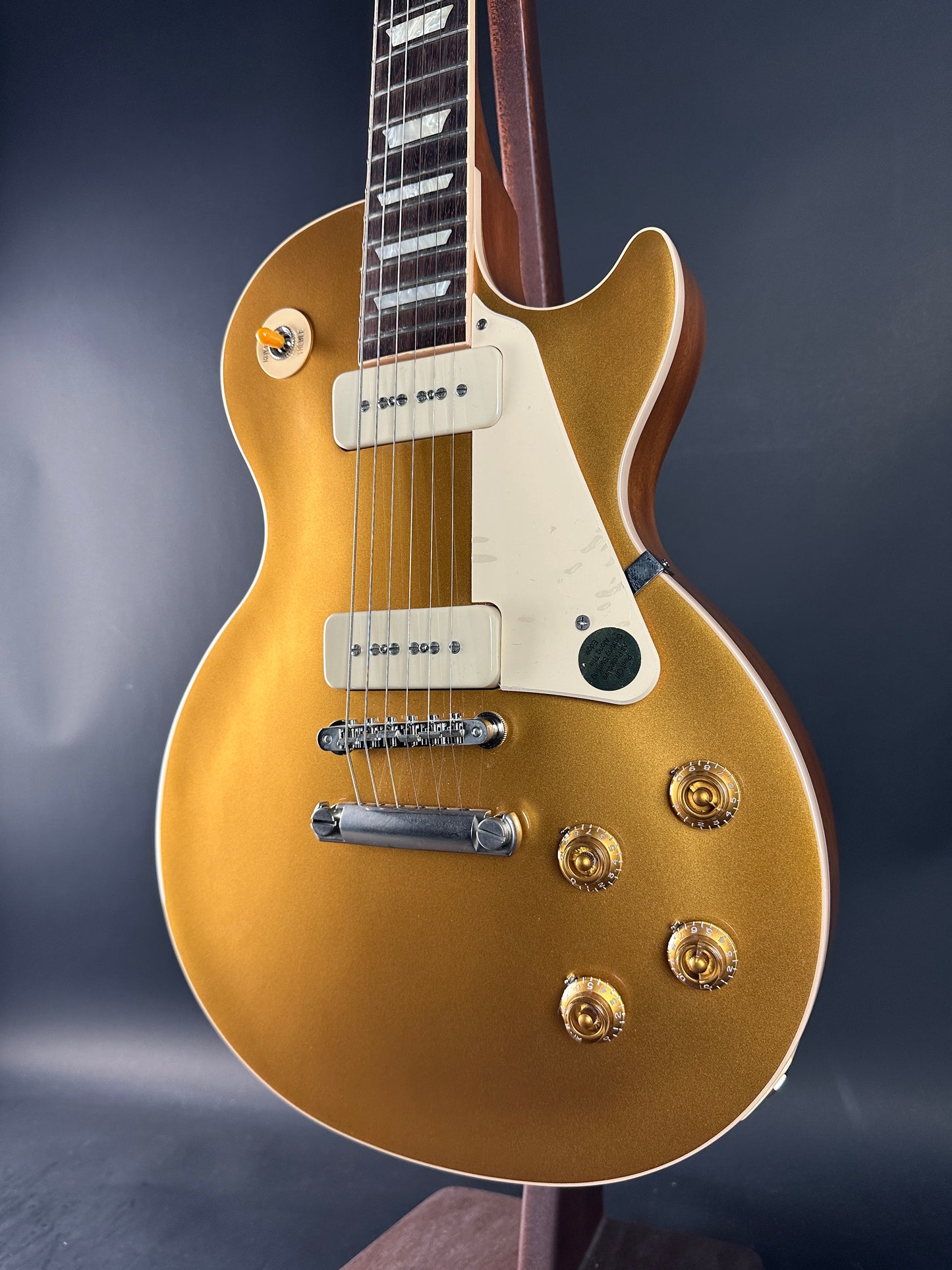 Gold electric guitar on a dark background