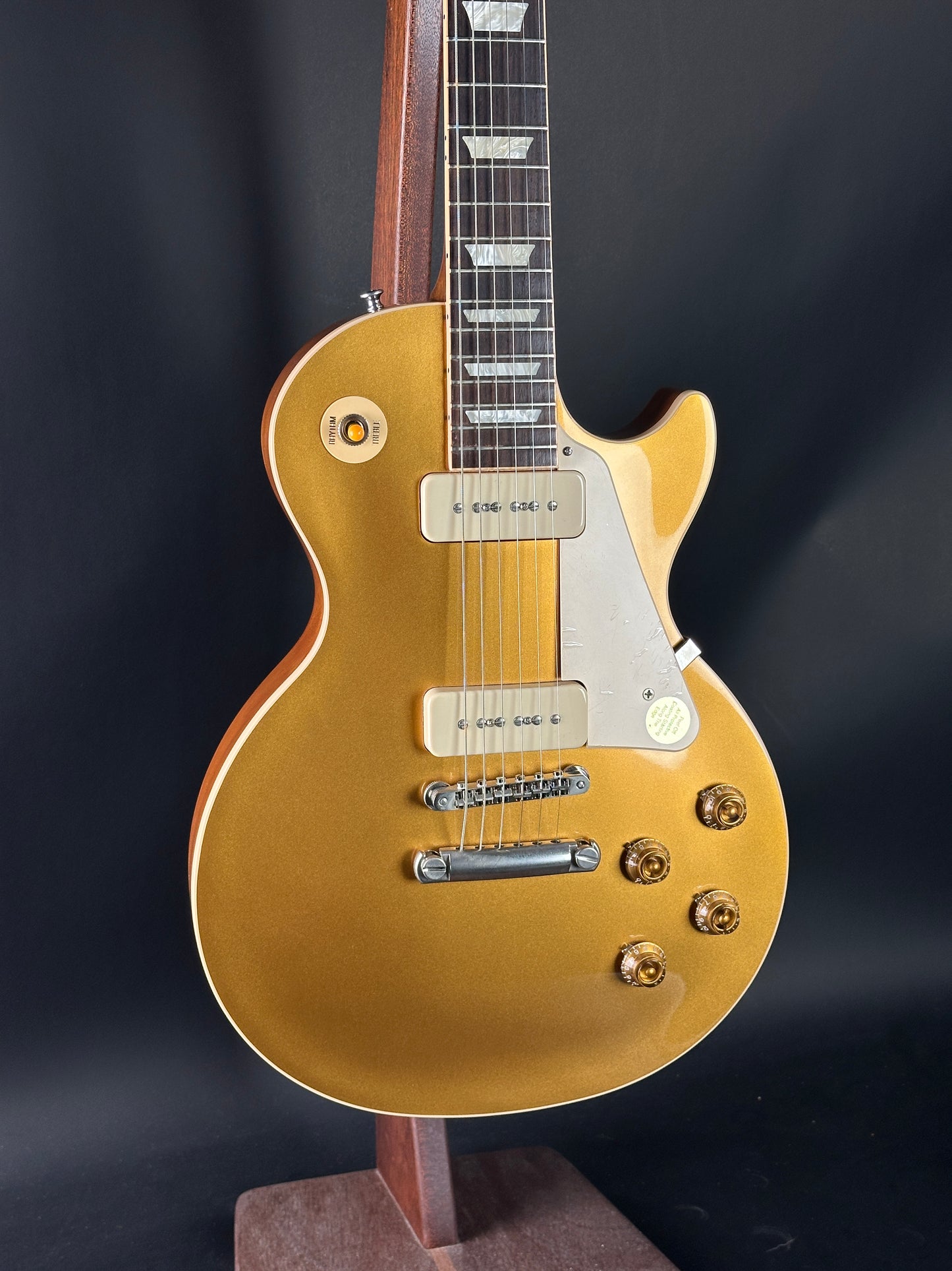 Gold electric guitar on a dark background