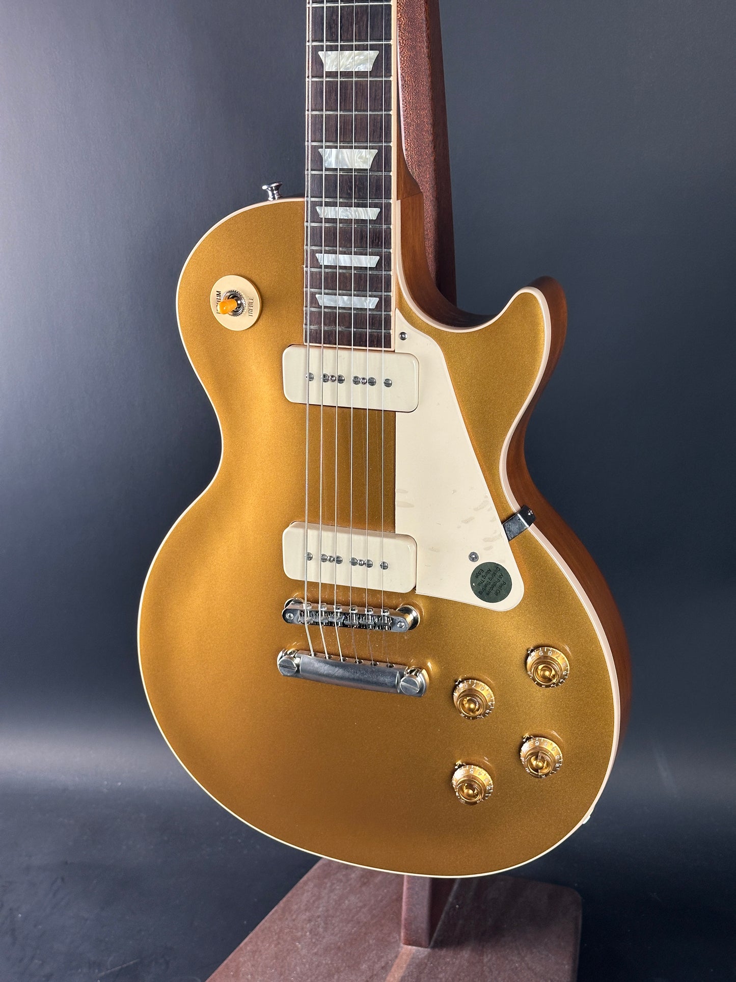 Gold electric guitar on a dark background