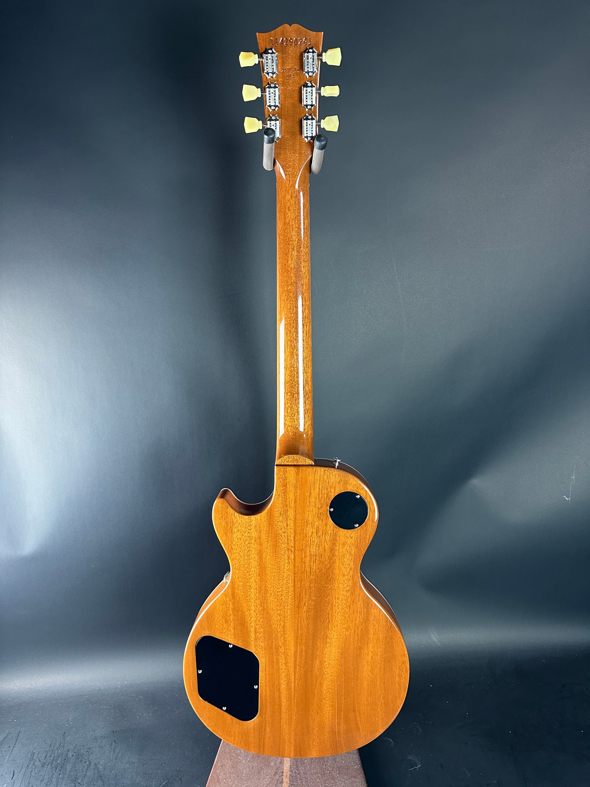 Wooden guitar on a dark gray background