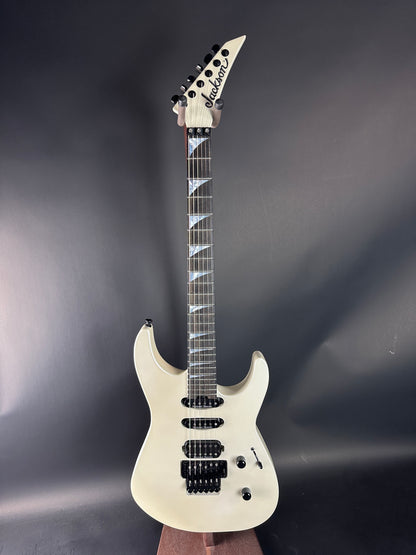 White electric guitar on a dark gray background